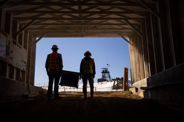 Silhouette of two people carrying a box in Butte, MT